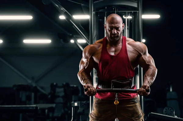 Kulturysta przystojny silny atletyczny człowiek pompowanie w górę biceps — Zdjęcie stockowe