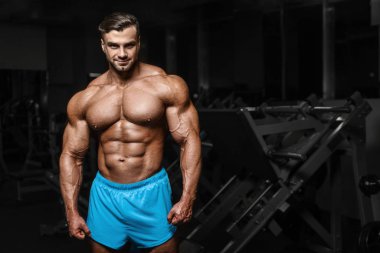 good looking fitness man pumping up muscles 