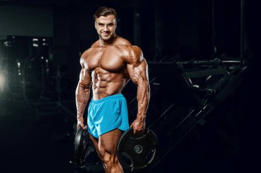 good looking fitness man pumping up muscles 