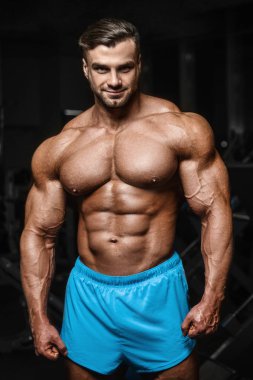 good looking fitness man pumping up muscles 