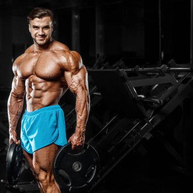 good looking fitness man pumping up muscles 