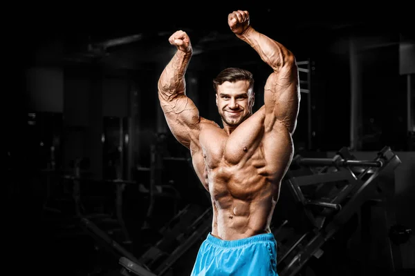 Good looking fitness man pumping up muscles — Stock Photo, Image