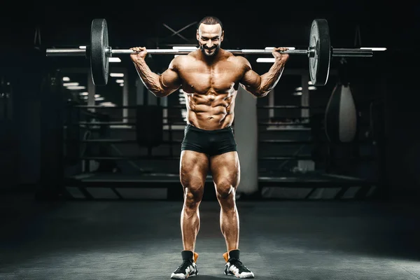 Adam Bacak Kaslarını Şişiriyor Vücut Geliştirme Konsepti Spor Salonu Arka — Stok fotoğraf
