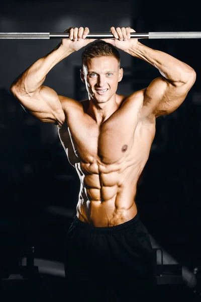 Strong athletic man fitness model showing six pack abs Stock Photo by  ©antondotsenko 126635864