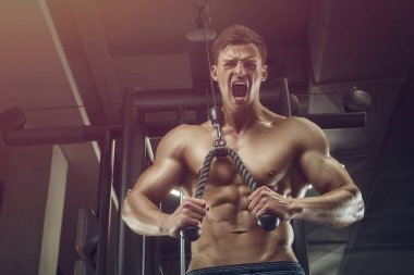 Vücut geliştiren yakışıklı, güçlü, atletik yakışıklı, kas geliştiren, vücut geliştiren sağlıklı bir vücut geliştirme uzmanı. Kas geliştiren, spor salonunda çıplak vücut egzersizleri yapan adamlar.