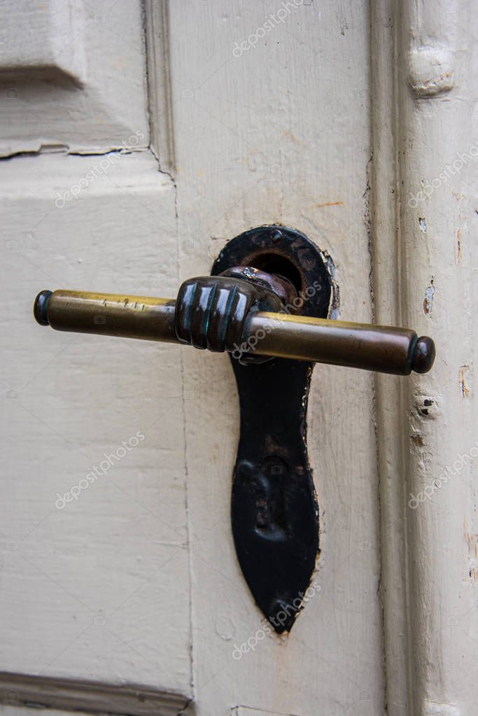 Unusual Old Brass Door Handle On A Wooden Door Stock Photo