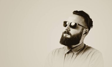 Siyah ve beyaz profilinde sakallı bir adam portresi. Adam şık bir saç kesimi ve temiz bir sakal vardır. 