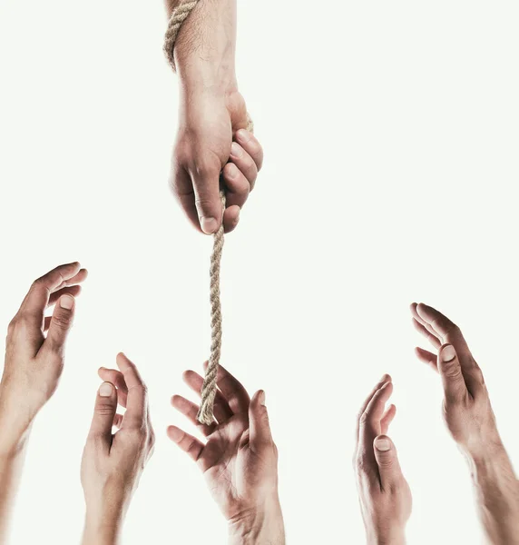 Human hand throws the rope to other people. Concept of salvation. Image.