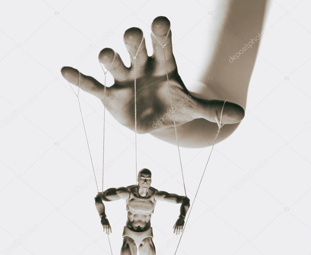 Concept of control. Marionette in human hand. Black and white image.