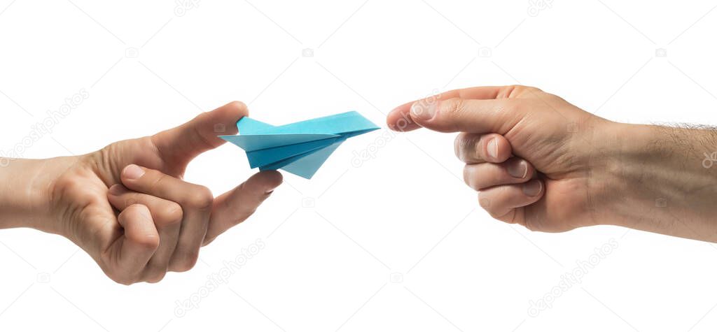 Person gives paper plane to another human. Concept of booking plane ticket, charters, tour. Isolated on white.