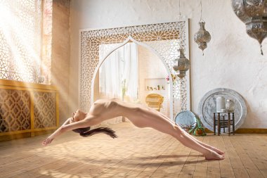 Güneş ışığı ile dolu odasında Levitating güzel çıplak kadın