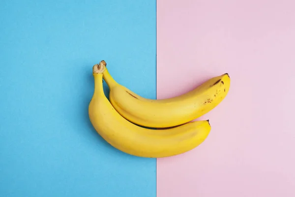 two ripe bananas on two-tone background