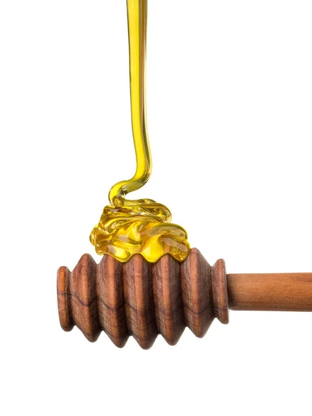 Honey on a wood dipper isolated on white background with clipping path — Stok Foto