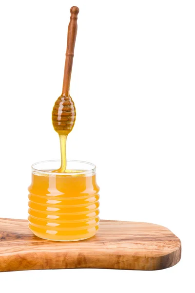 Tarro de vidrio lleno de miel y tarro de madera en tablón de madera aislado en blanco —  Fotos de Stock
