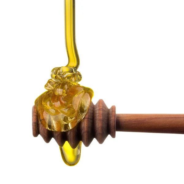 Honey on a wooden dipper isolated on white background with clipping path — Stock Photo, Image