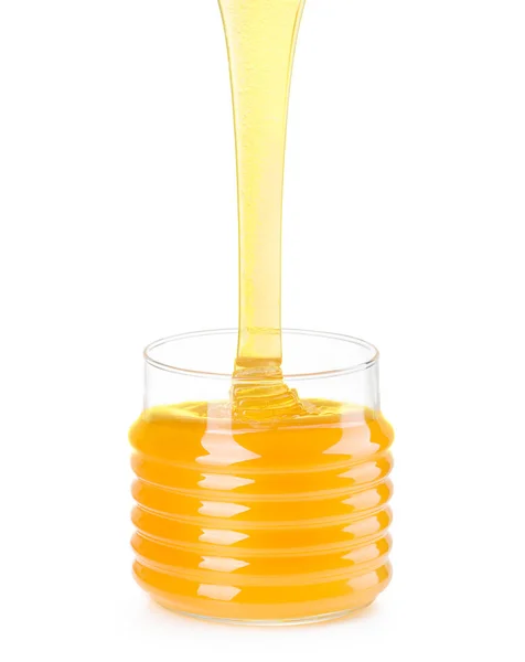 Glass jar of honey and falling jet of honey isolated on white background — Stock Photo, Image