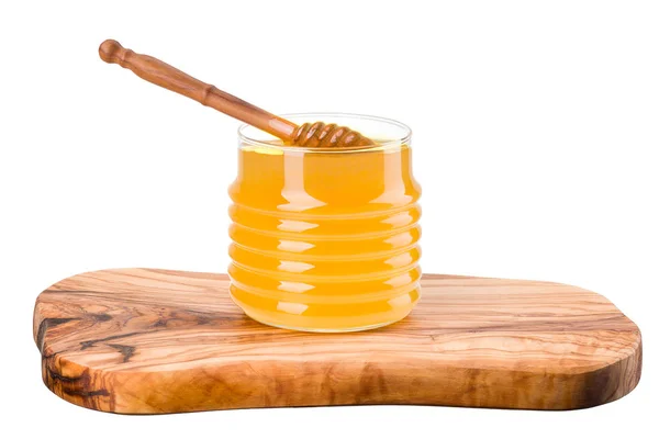 Glass jar full of honey and wooden dipper on wooden plank isolated on white — Stock Photo, Image