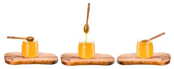 Set of honey jars on wooden plank isolated on white — Stock Photo, Image