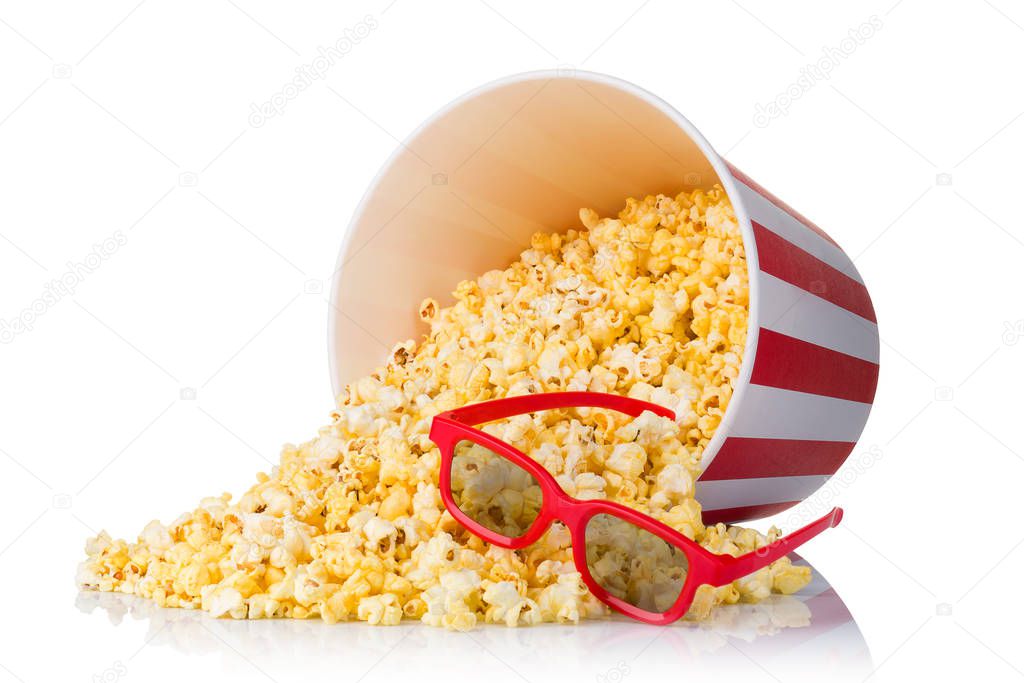 Scattered popcorn from paper striped bucket isolated on white background