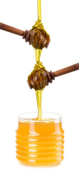 Glass jar full of honey and wooden dipper isolated on white background — 스톡 사진