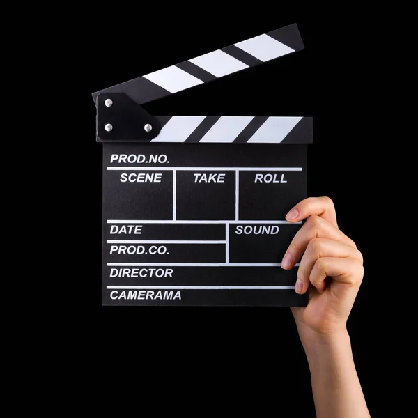 Human hand holding film clapper board isolated on black background — Stock Photo, Image