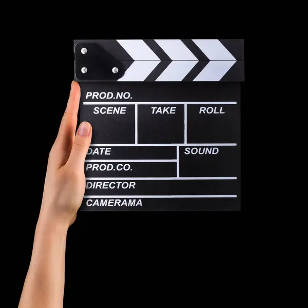 Mänsklig hand innehav film klappbräda isolerad på svart bakgrund — Stockfoto