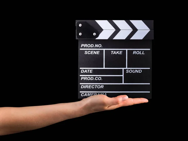 Human hand holding film clapper board isolated on black background — Stock Photo, Image