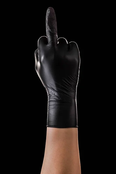 Hand in black gloves middle finger. Gesture of aggression or disrespect on black background. Isolated with clipping path.