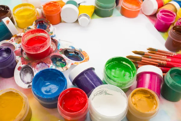 Tintas, pincéis e paleta sobre o fundo colorido . — Fotografia de Stock