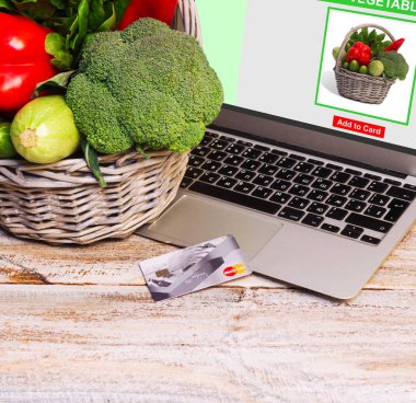 On-line Alışveriş kavramı. Internet bağlantısı, bir dizüstü bilgisayar satın sebze sepeti.