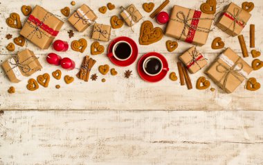 İki kırmızı kahve fincanı, bir kalp ve hediyeler şeklinde kurabiye 