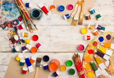 Fırçalar ve palet Beyaz ahşap zemin üzerinde.