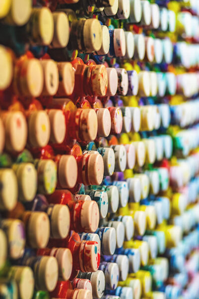 background of many cans of paint with lids lined up in a row, close-up