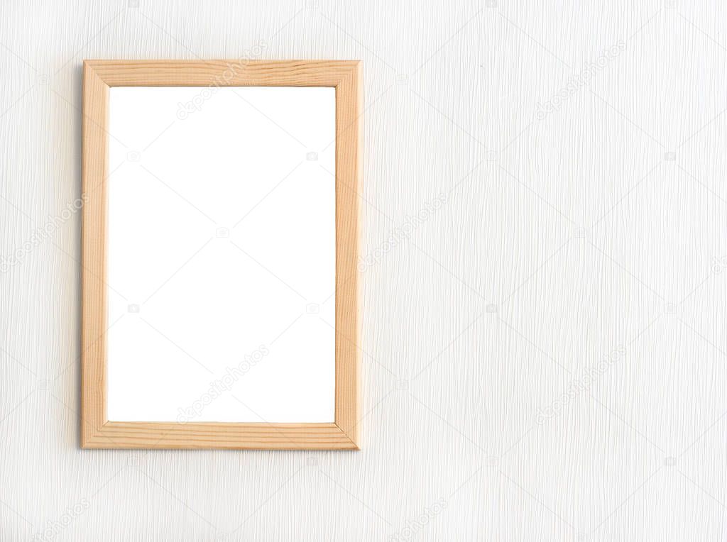 Light  wooden frame for picture hanging on white wall.Template for design       