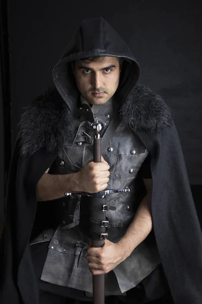Medieval or fantasy character in a leather jerkin with weapons