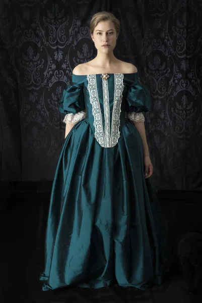 维多利亚时代的 文艺复兴时期的或18世纪的女人 穿着带花边的丝裙 背景是深色的 — 图库照片