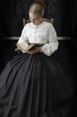 Kitap okuyan Viktoryalı bir kadın.