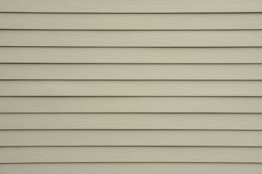 A background wall of tan shiplap siding. clipart