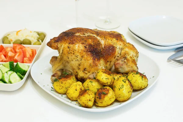 Roasted chicken and potatoes on white plate — Stock Photo, Image