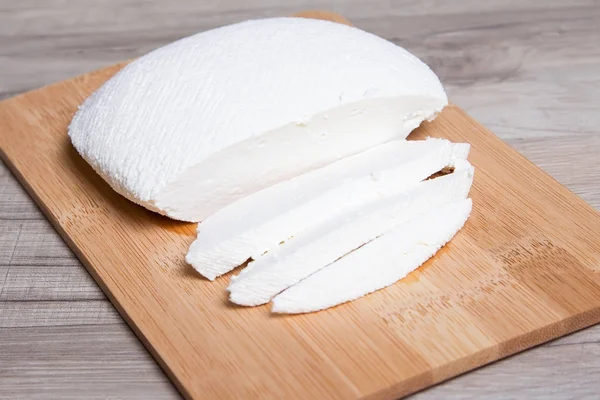 Homemade cheese brynza on a wooden board — Stock Photo, Image