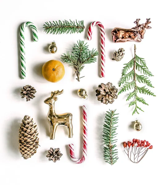 New Years unusual composition with spruce branches, sweets, mandarin, cones and gold deer. — Stock Photo, Image