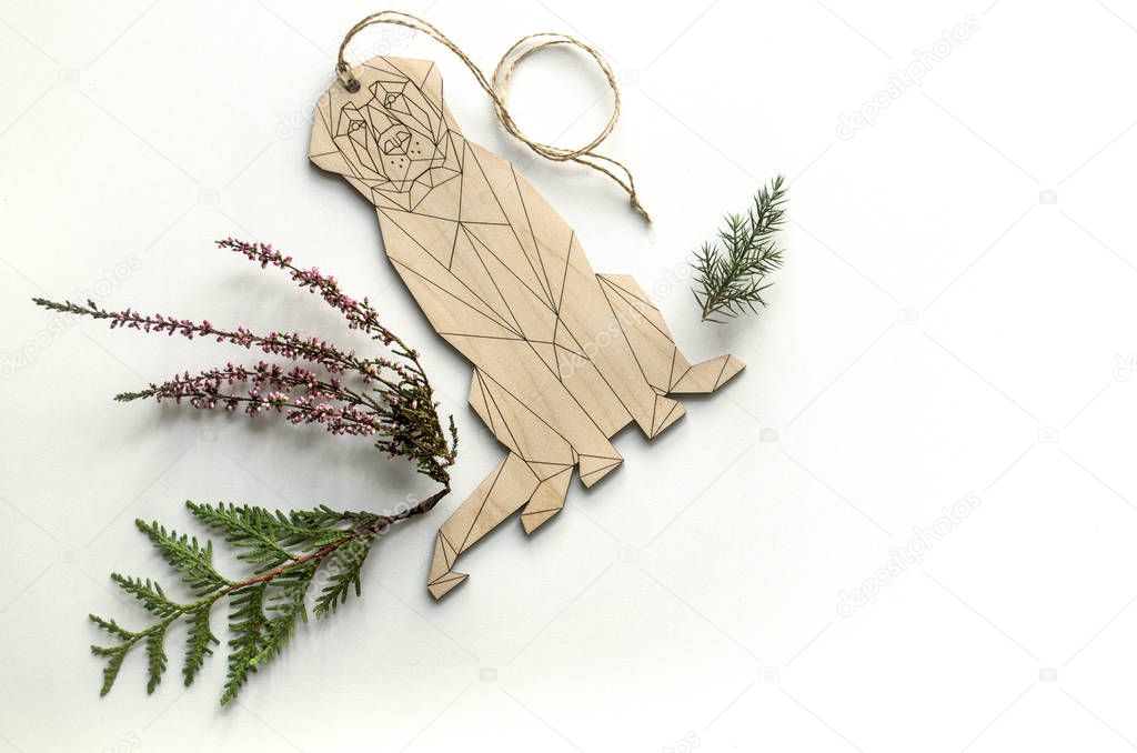 Composition with a dog-pendant and forest plants. Background for the presentation of work or text. Beautiful greeting card