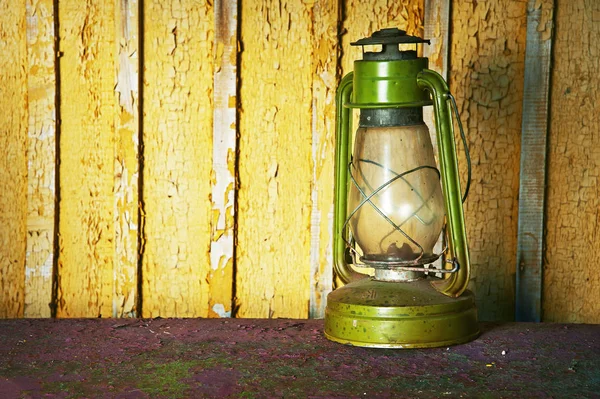 Kerosene lamp on a wooden background