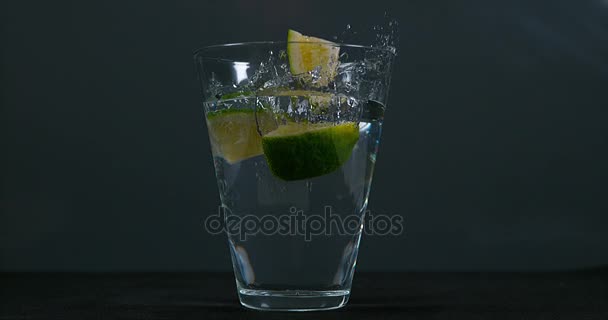 Green Citrus falling into a Glass — Stock Video