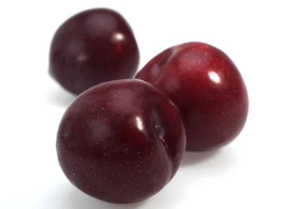 Red Plums White Background — стокове фото