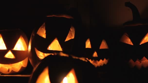 Светящиеся страшные тыквы ночью на ступеньках — стоковое видео