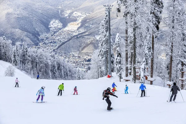 Skiers and snowboarders riding on a ski slope