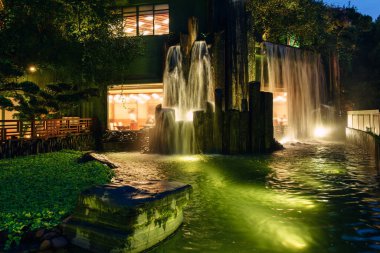 Hong Kong, Çin - 19 Ocak 2016: Hong Kong 'daki Diamond Hill' de Nan Lian Garden 'da şelalesi ve göleti olan bir kafe. Gece manzarası manzarası