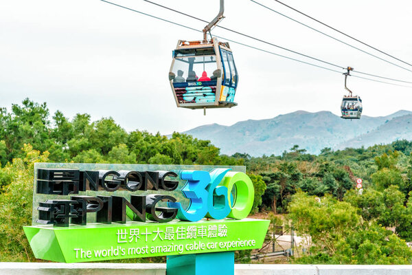 Hong Kong - January 26, 2016: Ngong Ping 360 Skyrail on Lantau Island in Hong Kong is the worlds most amazing cable car experience. Big sign on cableway lift background.