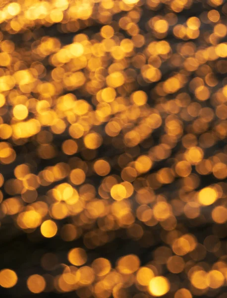 Blurred sparkling sun reflections on sea water defocused abstract bokeh nature texture background